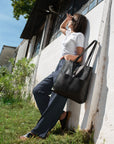Leather Tote Bag unlined hand bag. It features two open exterior pockets and one internal zippered pocket.