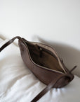 This full-grain leather Sling bag is designed for comfort and convenience, making it a great travel accessory or festival bag. With a durable metal zipper closure, cotton lining, and an adjustable strap, this versatile leather belt bag can be worn comfortably as a crossbody bag or hip bag. The back features an exterior zippered pocket for added security.