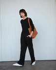 Leather Tote Bag unlined hand bag. It features two open exterior pockets and one internal zippered pocket.