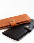 Natural-grained unlined wallet. It features a front snap closure, 8 card slots, 2 bill compartments plus a zippered interior pocket.