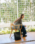 Andes L full grain leather backpack in black, front view, vegetable-tanned leather