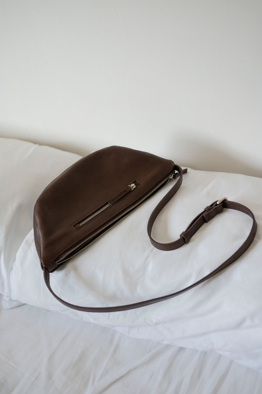 This full-grain leather Sling bag is designed for comfort and convenience, making it a great travel accessory or festival bag. With a durable metal zipper closure, cotton lining, and an adjustable strap, this versatile leather belt bag can be worn comfortably as a crossbody bag or hip bag. The back features an exterior zippered pocket for added security.