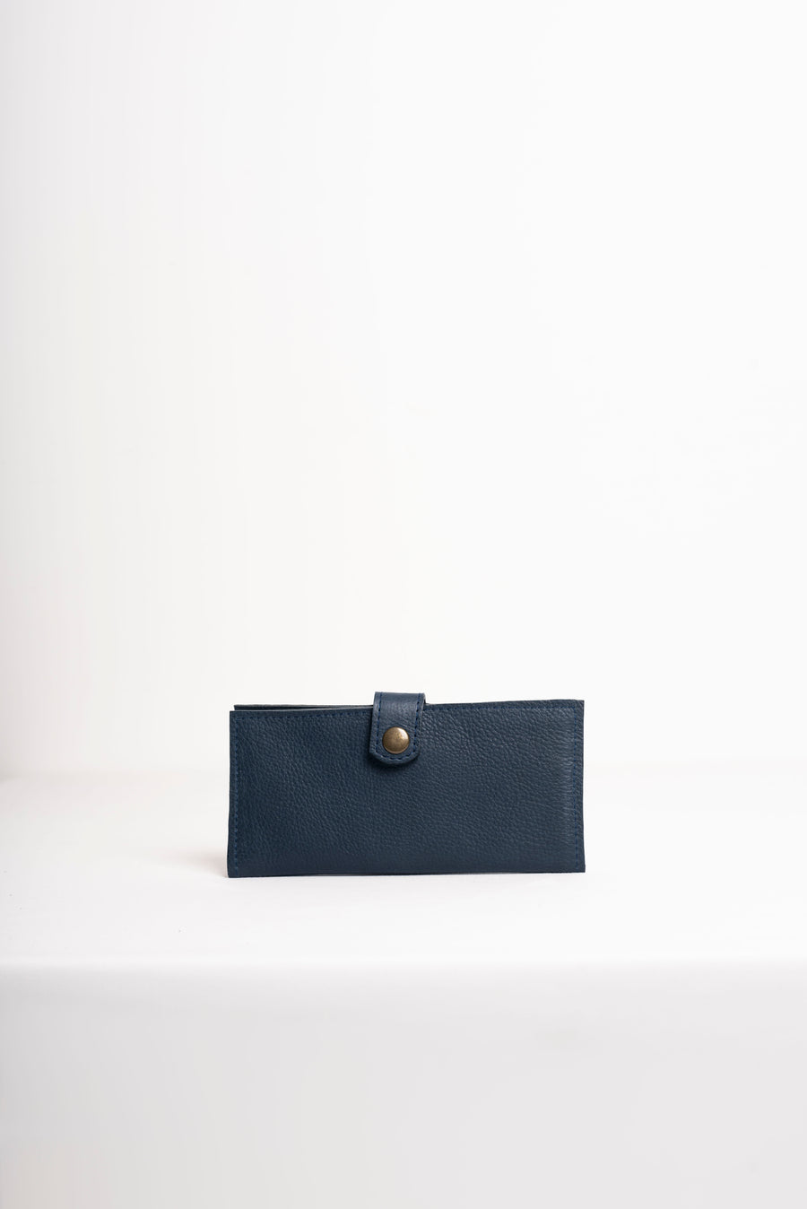 Natural-grained unlined wallet. It features a front snap closure, 8 card slots, 2 bill compartments plus a zippered interior pocket.