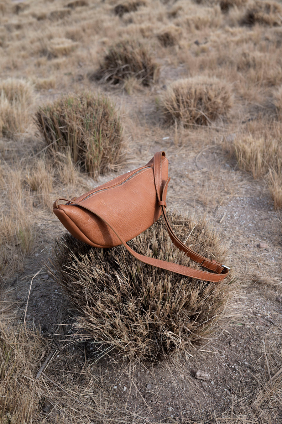 This full-grain leather Sling bag is designed for comfort and convenience, making it a great travel accessory or festival bag. With a durable metal zipper closure, cotton lining, and an adjustable strap, this versatile leather belt bag can be worn comfortably as a crossbody bag or hip bag. The back features an exterior zippered pocket for added security.