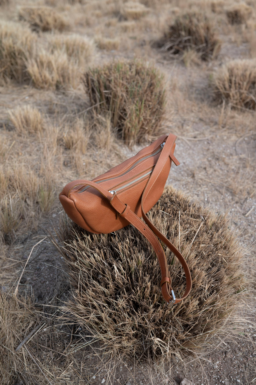 This full-grain leather Sling bag is designed for comfort and convenience, making it a great travel accessory or festival bag. With a durable metal zipper closure, cotton lining, and an adjustable strap, this versatile leather belt bag can be worn comfortably as a crossbody bag or hip bag. The back features an exterior zippered pocket for added security.