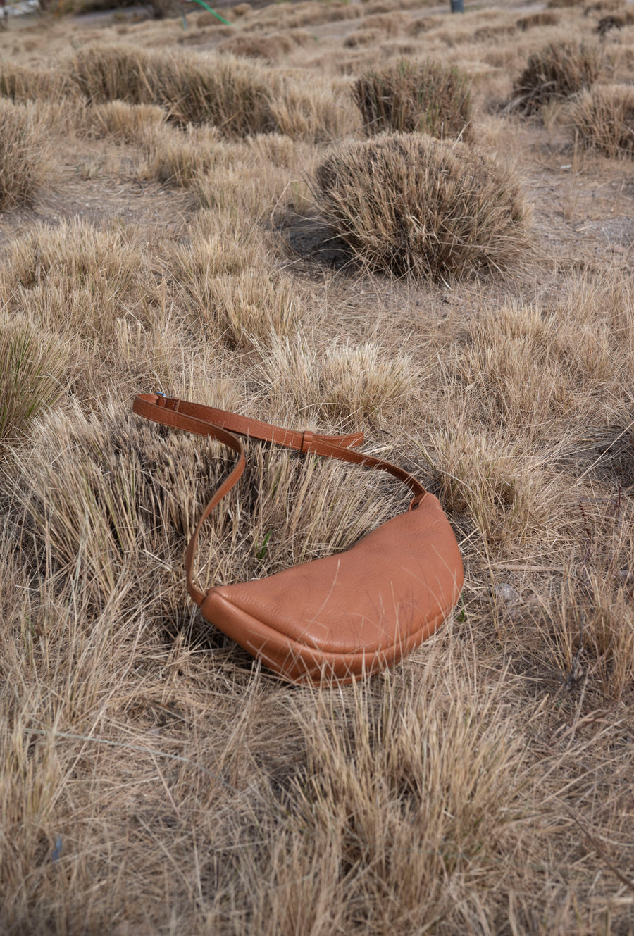 This full-grain leather Sling bag is designed for comfort and convenience, making it a great travel accessory or festival bag. With a durable metal zipper closure, cotton lining, and an adjustable strap, this versatile leather belt bag can be worn comfortably as a crossbody bag or hip bag. The back features an exterior zippered pocket for added security.