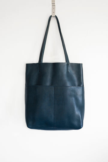 Full grain leather unlined tote bag. It features two interior pockets
