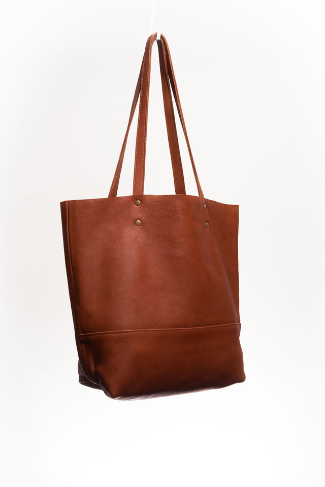 Full grain leather unlined tote bag. It features two interior pockets, one zippered, and one open.&nbsp; It comes with fixed leather handles.