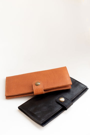 Natural-grained unlined wallet. It features a front snap closure, 8 card slots, 2 bill compartments plus a zippered interior pocket.