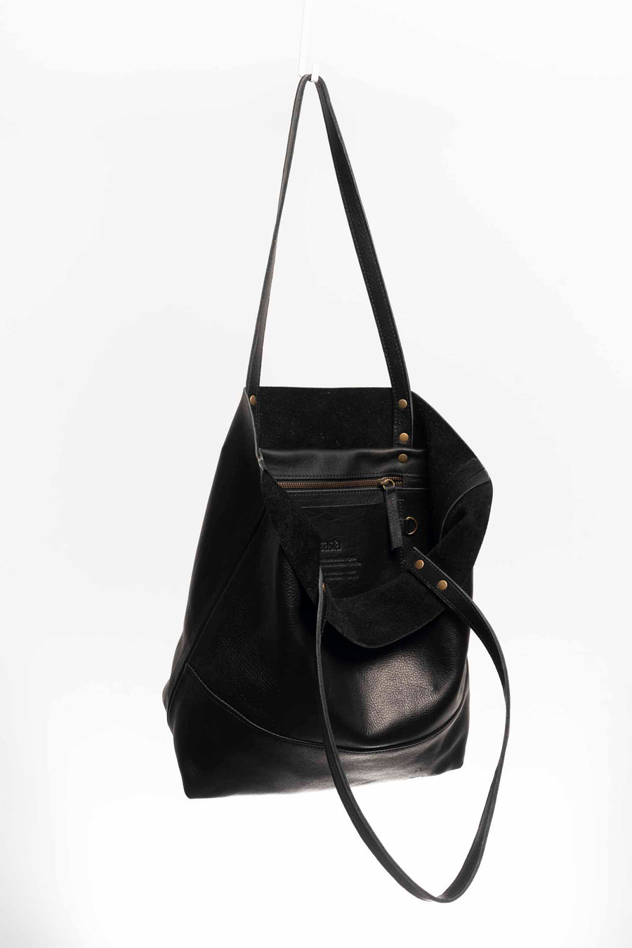 Full grain leather unlined tote bag. It features two interior pockets