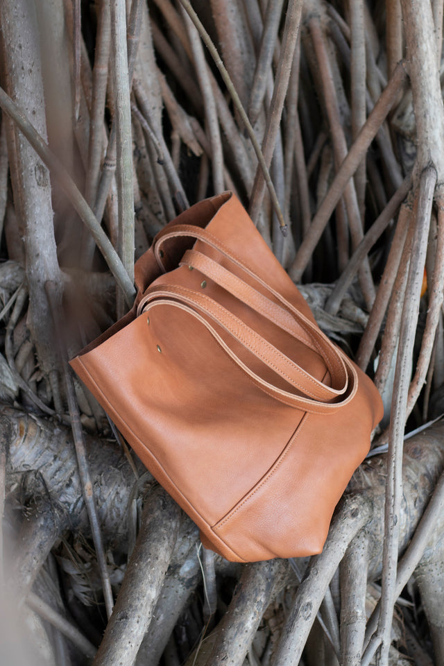 Full grain leather unlined tote bag. It features two interior pockets