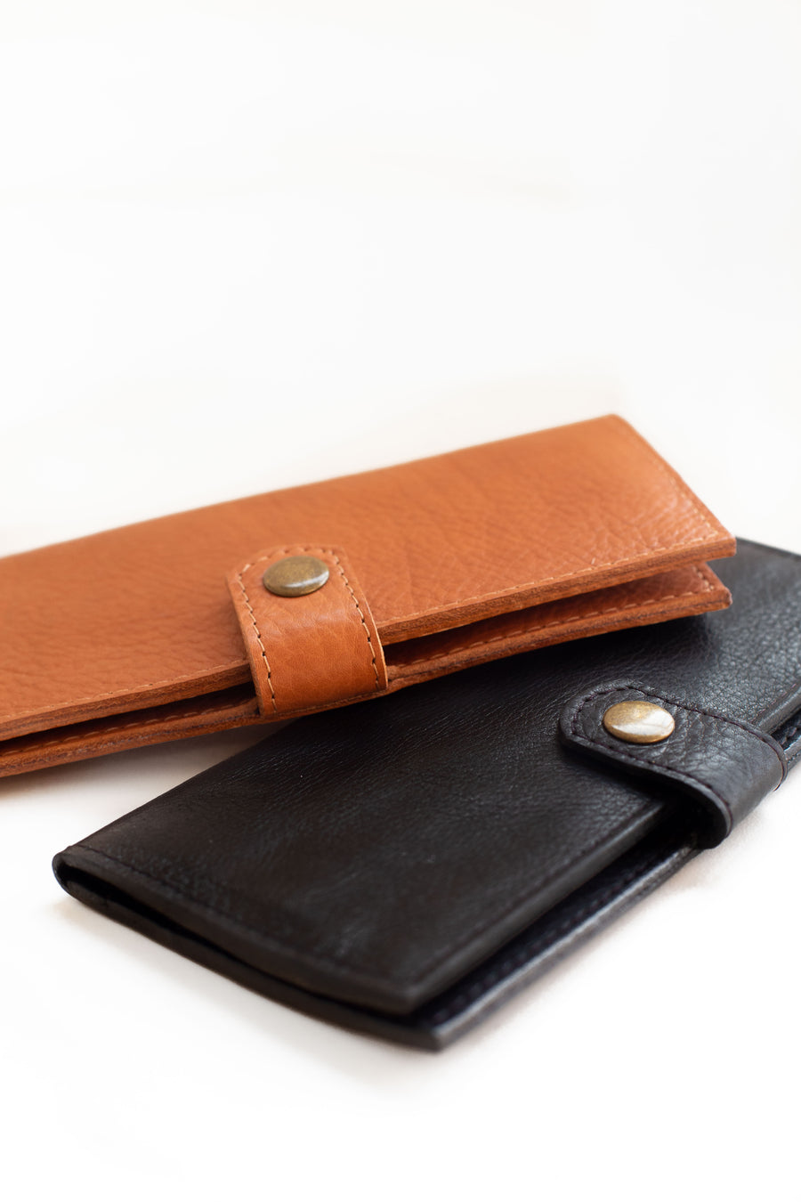 Natural-grained unlined wallet. It features a front snap closure, 8 card slots, 2 bill compartments plus a zippered interior pocket.